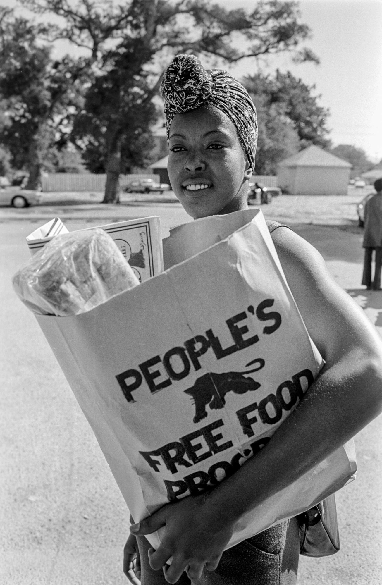 Woman with a bag of food at the People's Free Food Program, one of the survival programs, Palo Alto, California ,1972. © Stephen Shames